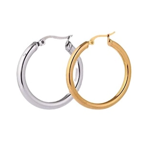 Detailed close-up of classic polished gold and silver hoop earrings in a minimalist style