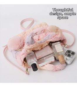 Detailed interior of pink gradient quilted nylon cloud bag with plush ball charm