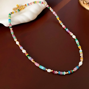 Detail of 18K gold plated necklace with colorful beads and white baroque pearls