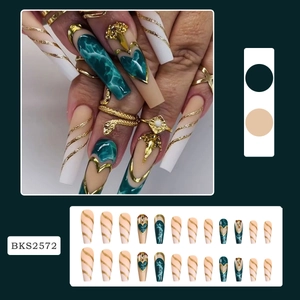 Detail showing long trapezoid press-on nails with dark green marble and gold glitter