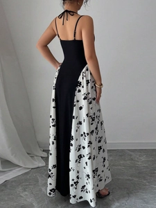 Robe longue dos nu élégante avec haut licou noir et jupe à imprimé floral chic