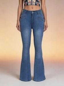 Detail view of blue flared jeans featuring mid-rise slim fit and vertical panel stitching