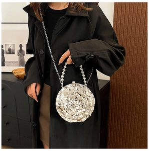 Detailed view of 3D silver rose flower handbag with beaded handle and metal chain