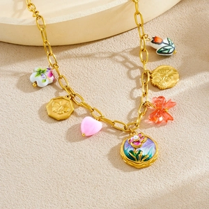 Vintage gold necklace set with colorful ceramic flower, relief coin, and resin heart charms