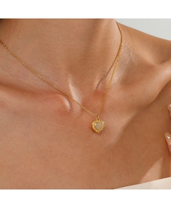 Close-up of 14K gold plated heart necklace featuring an opal-like gemstone on a model