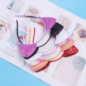 Detail of colorful glitter cat ear headbands set in pink, purple and orange colors