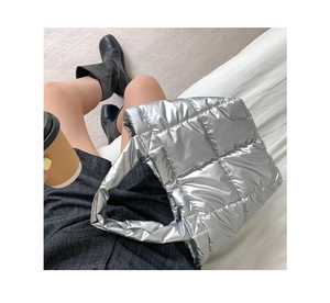 Detailed top view of silver padded nylon quilted tote bag for women in casual scene