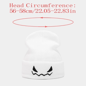 Close-up of white knit beanie featuring black ghost face embroidery and 56-58cm size detail