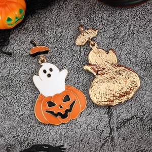 Enamel Halloween ghost and pumpkin earrings with gold metal base on grey background