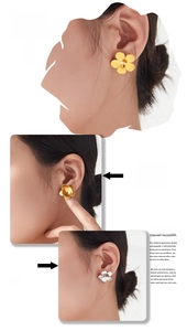 Detail view of five-petal flower stud earrings in matte gold and silver finishes