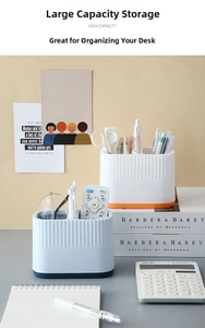 Close-up of dual-slot desk organizer with vertical stripes showing office supply storage