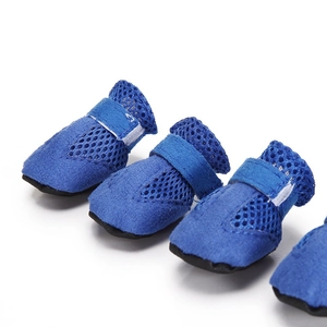 Close-up of four breathable blue mesh dog shoes for summer outdoor walking and running