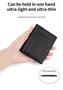 Detailed view of an ultra-thin 0.8cm black lychee leather card holder held in one hand