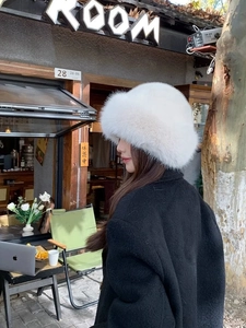 Detailed texture of white faux fur winter bucket hat showing fluffy Russian style fiber