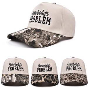 Embroidered Somebody's Problem trucker hats with various camo and leopard print brims