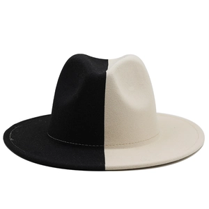 Close-up of the contrast stitching and texture on a two-tone black and beige wool fedora hat