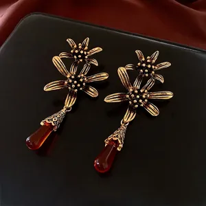 Vintage gold flower drop earrings with reddish-brown amber teardrop pendants