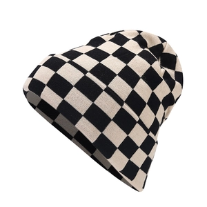 Retro checkered knit beanie hat in black and white for winter warmth and fashion