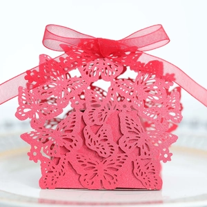 Close-up of red laser-cut butterfly candy box with a matching organza ribbon bow