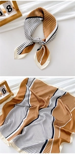 Detail of elegant square silk scarf with geometric color block and stripe patterns
