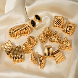Vintage 18k gold plated stainless steel geometric earrings on champagne silk fabric