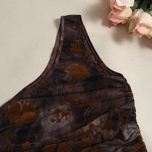 Detail of dark brown mesh top with velvet floral flocking and irregular neckline