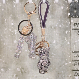 Close-up of sparkling rhinestone bear keychains with matching glitter leather straps