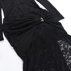 Close-up of black lace dress waist featuring gold ring detail and pleated fabric texture