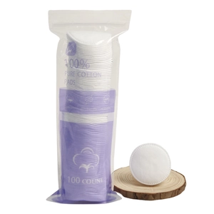 100pcs round pure cotton makeup pads in purple bag on wooden stand for face cleaning