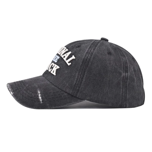 Detail view of washed black baseball cap featuring vintage distressing and 3D embroidery