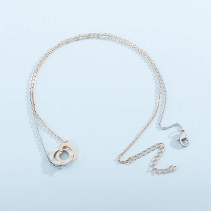 Two-tone interlocking heart ring necklace with silver rhinestones and rose gold bands