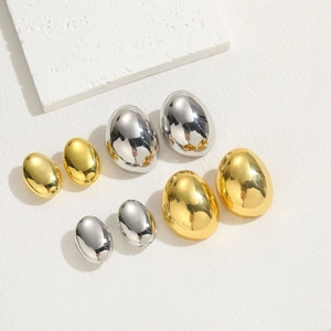 Polished oval metallic huggie hoop earrings in gold and silver finishes and sizes