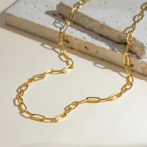 Minimalist gold stainless steel paperclip chain necklace for daily wear on stone