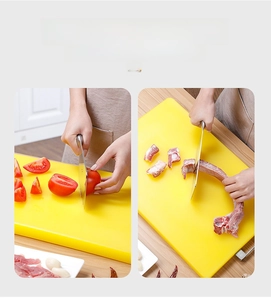 Detailed view of yellow PE cutting board with side metal handle on wooden tabletop