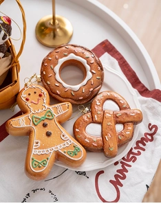Detailed view of gingerbread man, donut and pretzel Christmas tree hanging decorations