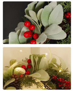 Detail of Christmas wreath with pine cones, red berries, and festive LED string lights