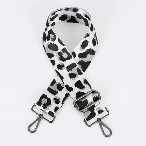 Macro shot of leopard print replacement bag strap with dark grey metal lobster hooks
