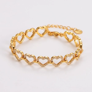 Détail macro du bracelet à maillons cœurs dorés serti de zircons blancs étincelants