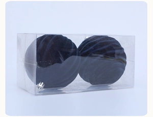 Detail of two dark blue flocked Christmas balls in a transparent box with silver hanging caps