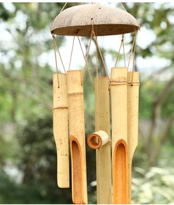 Detailed macro view of natural bamboo tubes and coconut shell top on handmade wind chimes
