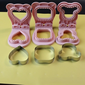 Macro detail of heart, square, and bear-shaped stainless steel sandwich cutters