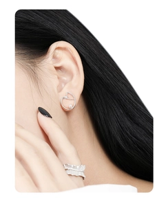 Detail of s925 silver irregular heart earrings with pearls and a textured ring