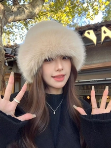 Detail shot of fluffy faux fur winter bucket hat in cream white with soft plush texture