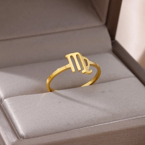Macro detail of gold-plated stainless steel Virgo zodiac sign ring in a jewelry box
