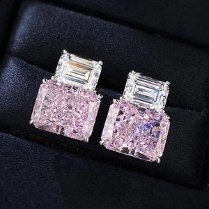 Macro shot of a rectangular pink and white cubic zirconia earring in a blue velvet gift box