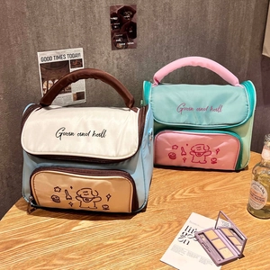 Detail of multi-layered storage and portable handle on the cute cartoon makeup bag