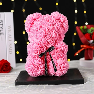 Detailed view of a 25cm pink PE foam rose bear with a black Just for you ribbon
