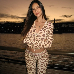 Detail of leopard print tracksuit featuring hooded zip-up cardigan and slim trousers