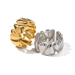 Detail of interlocking heart-shaped adjustable rings in gold and silver finishes