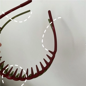 Detail view of double-layer serrated teeth on matte plastic headband for hair grip
